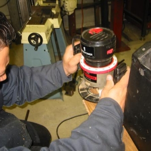 Johnny worked the wood tools. Here he is trimming for the corner brackets.