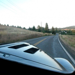 The view over the hood on my ride in the coupe.  The town which consists of a tavern, volunteer fire dept, a school that is now used for a community center and a store that has been closed down is in the distance where the trees are.