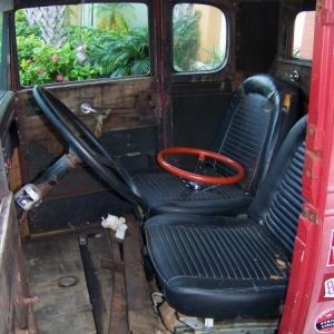 Original wood is still there and should be usable to apply the new pure white (or pearl white) tuck & roll upholstery. Those are '59 Thunderbird buckets that will look terrific with the roll cage eventually. That orange metal flake Moon wheel will look killer as well!