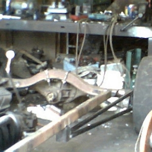 Model A rear spring and crossmember with homemade lader bars.