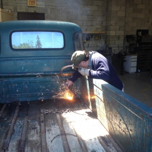 Dad burning the rusty bed bolts